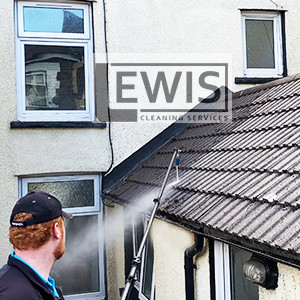 Roof cleaning service removing moss and debris from roof tiles in Cardiff